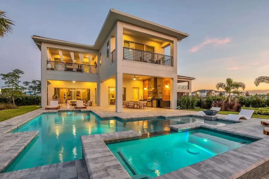 Vacation home pool lit at dusk